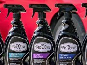 five bottles of Pro X One car care cleaning products