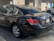 A black Honda Accord defaced by wife finding out she was cheated on