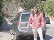 L.A. Musician Jordan Hook standing in front of his Subaru Forester damaged by that flying Tesla Model S from Alex Choi video