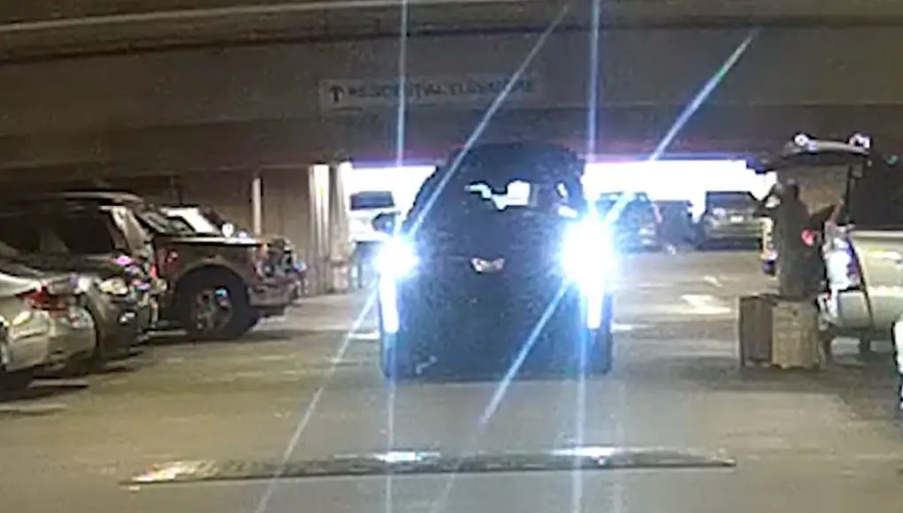 An Escalade owner reverses his tailgate into a parking garage ceiling