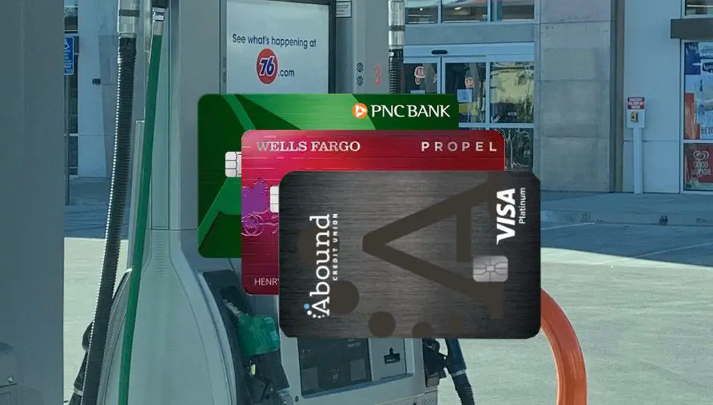 Various credit cards in front of a gas pump