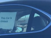 Sign on car in bay Area that says, "This car is unlocked"