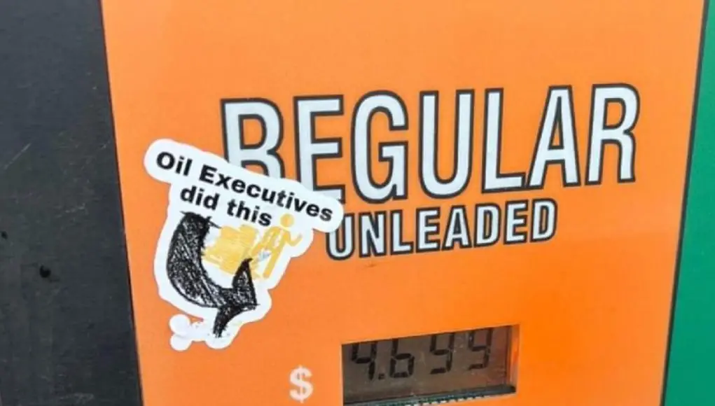 A gas pump sticker that reads "Oil Executives did this."