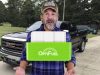 older guy with a hat in front of a truck on Youtube talking about a fuel saver device