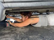 A catalytic converter thief is caught in action in the act of stealing a catalytic converter