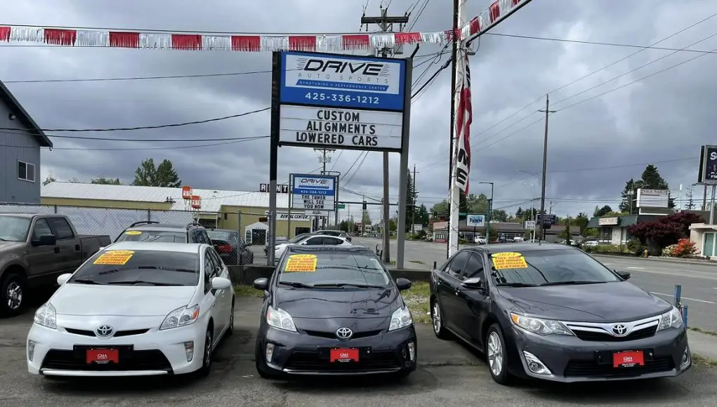 Nissans and Toyota on a used car lot imported from South Korea