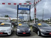 Nissans and Toyota on a used car lot imported from South Korea