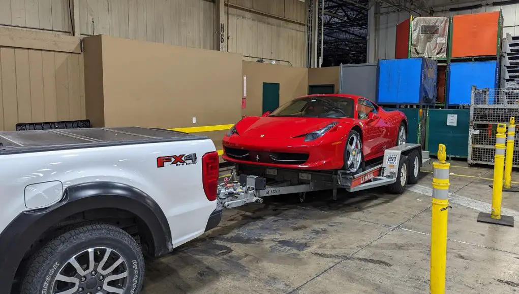 A Ferrari 458 on a U-Haul trailer owned by a boss who gave an employee a 25 cent raise