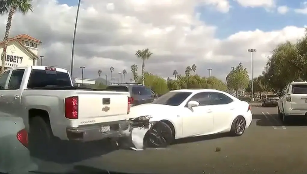 Chevrolet Silverado running over the front bumper of a Lexus IS