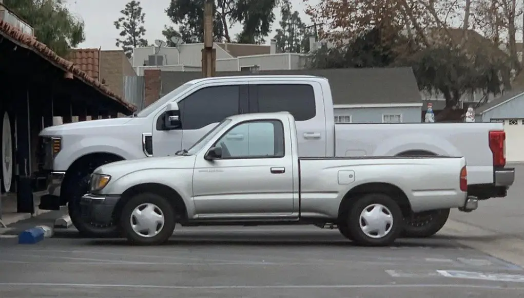 Ford F-250 parked next to a 2000s Toyota Tacoma