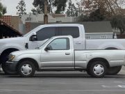 Ford F-250 parked next to a 2000s Toyota Tacoma