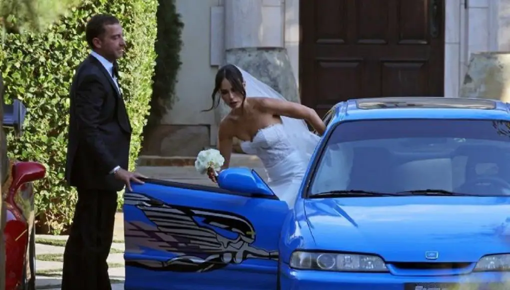 Jordana Brewster gets into a blue Acura Integra made to look like the one she drove in the first Fast and Furious