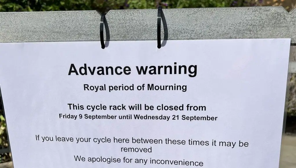A sign on a bike rack in front of Norwich, England Town Hall saying the rack is closed for a Royal Period of Mourning to commemorate the Queen