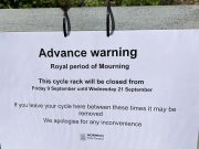 A sign on a bike rack in front of Norwich, England Town Hall saying the rack is closed for a Royal Period of Mourning to commemorate the Queen