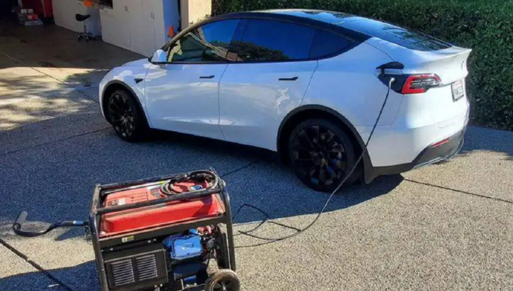 A Tesla Model Y being charged by a gas generator
