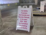 A-frame sign warning 2020-2022 Hyundai Palisade and Kia Telluride owners they're forbidden from parking at this particular Nashville parking garage