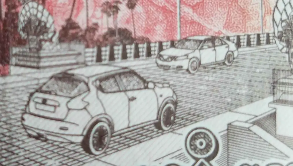The Cambodian 500 Riel banknote showing a bridge over the Mekong River with a Toyota Camry and Nissan Juke driving across it.