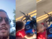 Dad films himself riding on his motorcycle, his daughter in front of him, both without helmets.