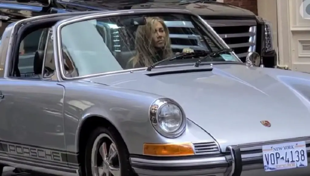 Jennifer Aniston behind the wheel of a classic Porsche 911 Targa