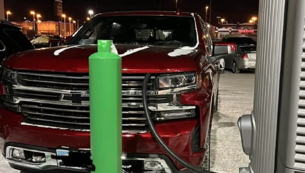 A Chevrolet Silverado gas truck takes up a parking space meant for EVs at this Anchorage, AK shopping center