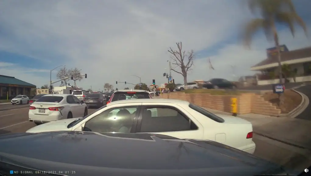 Woman in Toyota Camry in Mira Mesa blocks traffic after incorrectly yielding.