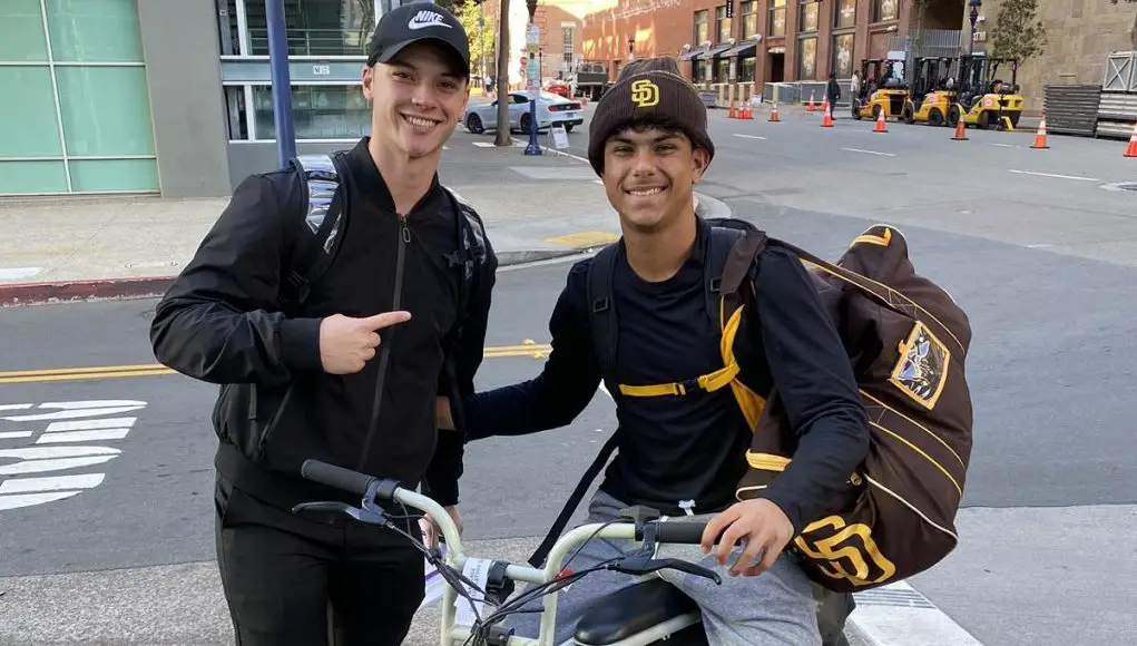 Ethan Salas poses with a fan while on his e-bike.