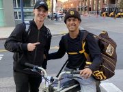 Ethan Salas poses with a fan while on his e-bike.