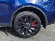 A Tesla Model Y with its rear wheel jacked up
