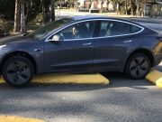 A Tesla Model Y is stuck on a raised lane divider in Surrey, BC