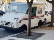 A USPS worker crashes his truck between two cars in downtown San Diego.