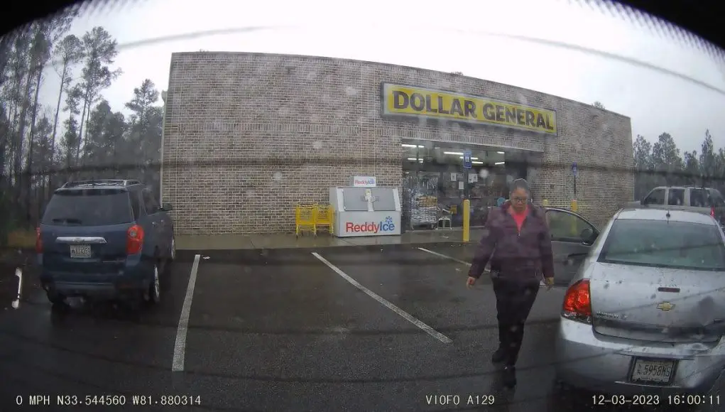 Lady assesses damage to her car after causing accident in Graniteville, SC Dollar General
