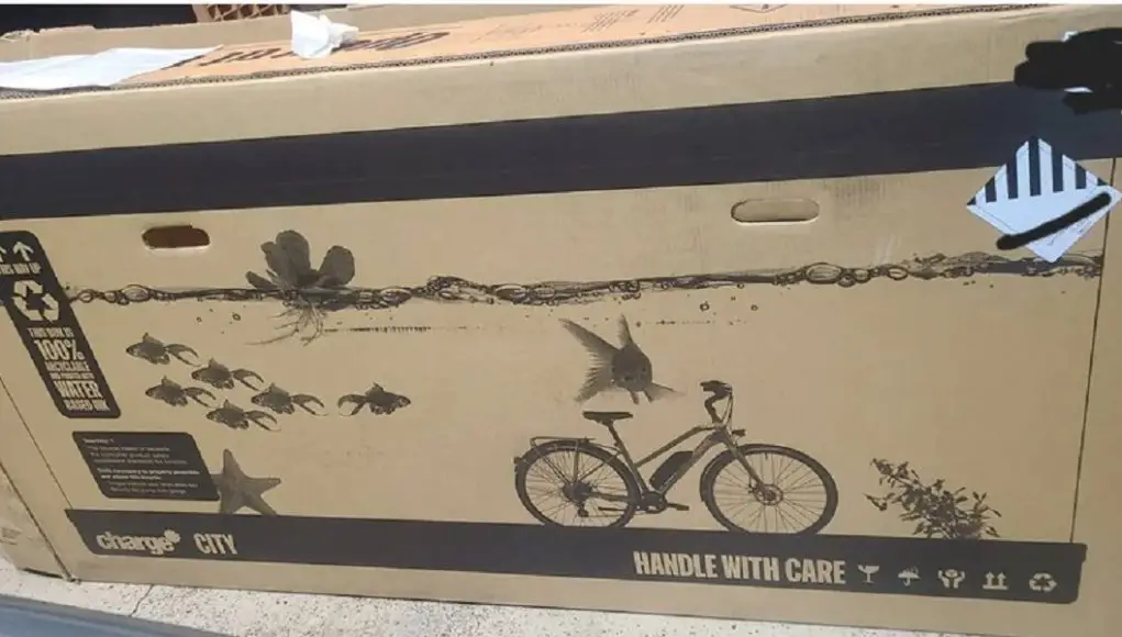 A cardboard box to ship bikes that has an aquarium design photo on it.