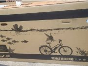A cardboard box to ship bikes that has an aquarium design photo on it.
