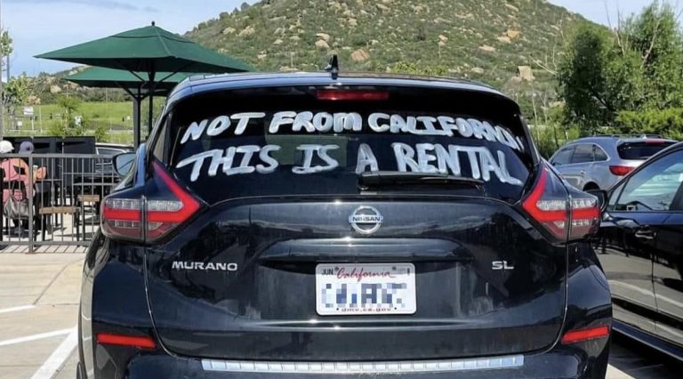 A Nissan Murano rental with "I'm not from California. This is a rental" written on the back.