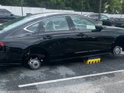 A Honda Accord with stolen wheels sitting on a lot in Maryland