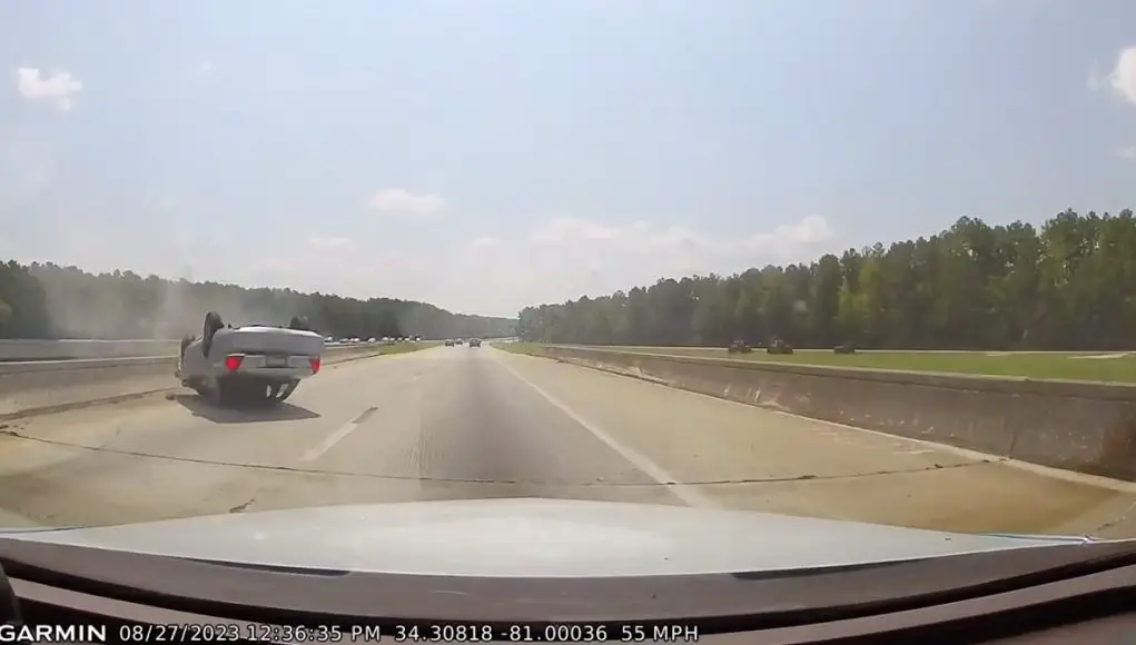 Ford Crown Victoria flips after failing to merge correctly.