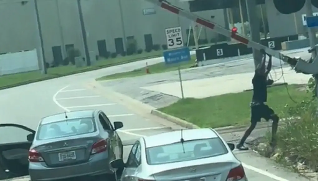 This guy really tried to lifting the railroad crossing arms to get through.
