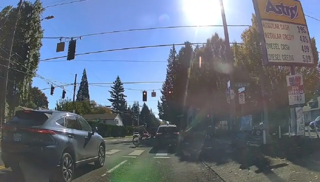 Subaru Crosstrek with Share the Road vanity plate in Portland runs red light