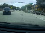 Driver in West End, Miami Florida goes through intersection despite red light.