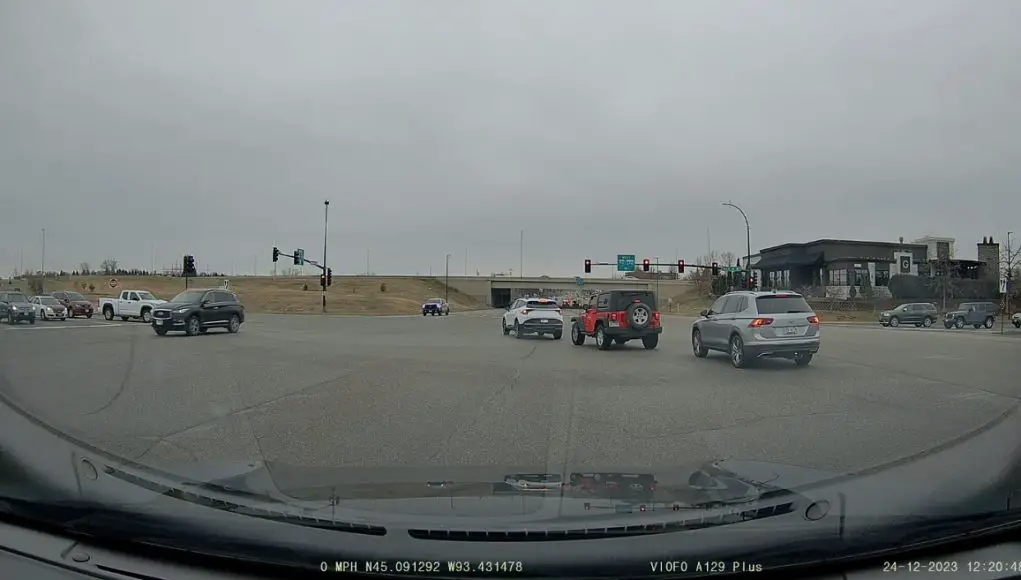 Drivers turn left on red after an ambulance in Maple Grove, MN.