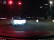 Driver fleeing policein Aubrey, TX runs red light and narrowly avoids hitting driver legally turning left.