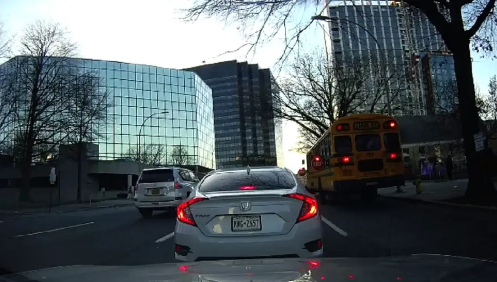 Drivers in White Plains, NY drive by stopped school bus letting kids off.