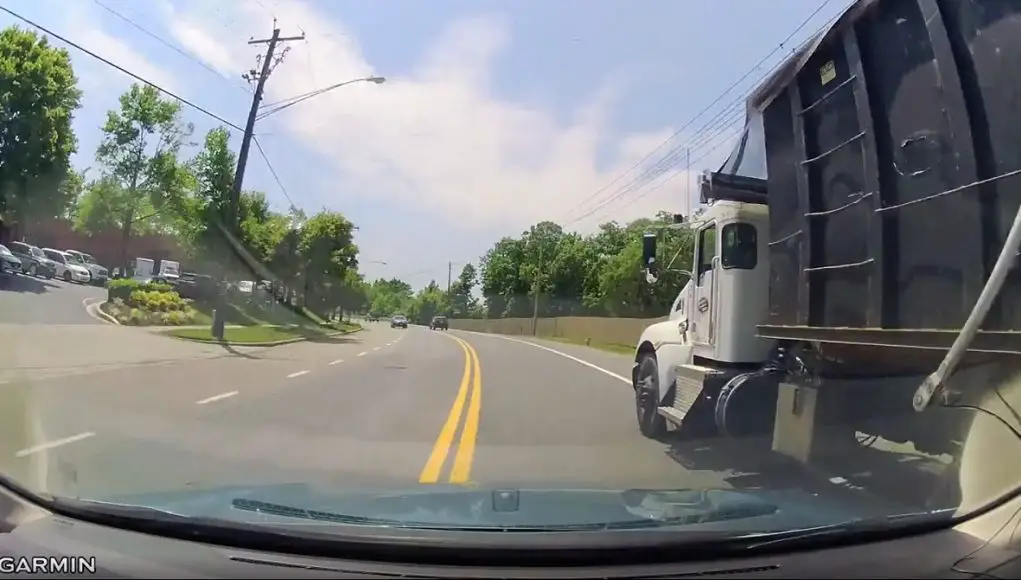 Garbage truck driver in Beltsville, MD passes dangerously on the shoulder.