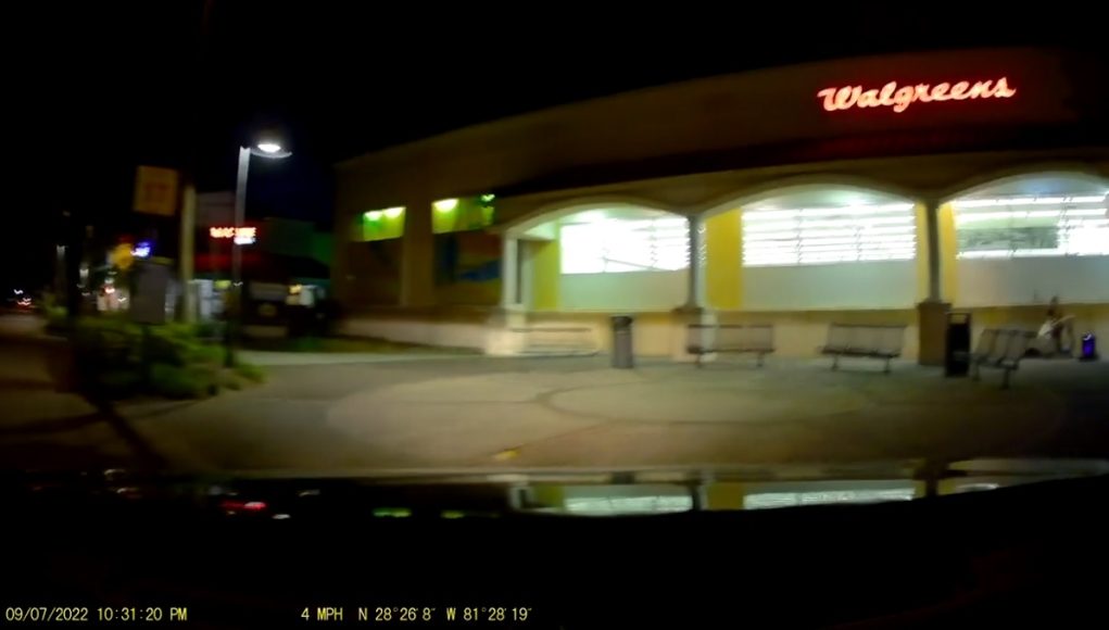 Driver in Orlando, FL enters Walgreens from the wrong direction, using the sidewalk.