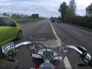 Crazy driver passes Motorcyclist in the same lane.