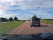 A driver on I-29 in South Dakota blocks a late merger from driving forward.