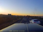 A driver in a Camaro pulls an unsafe merge in front of a semi.