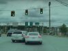 Driver in Martinsburg W.VA enters part of intersection meant to stay clear, does an illegal intersection lane change, and hits car in front of sheriff.