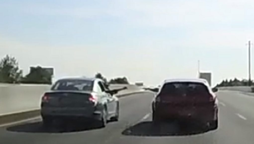 Two vehicles on I-95 in Wilmington, DE come close to each other to pass what looks like a blunt.
