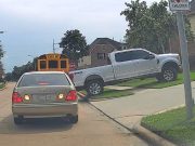 A Tomball, TX resident drives over a sidewalk and angles his way into his own driveway to bypass cars waiting for school bus to leave.